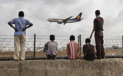 Habitantes de Mumbai observan el aterrizaje de un avi&oacute;n de Jet Airways. 